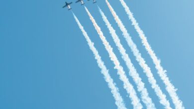 Ontario Trails - Jet planes performing an aerial display with smoke trails against a clear blue sky in Toronto.