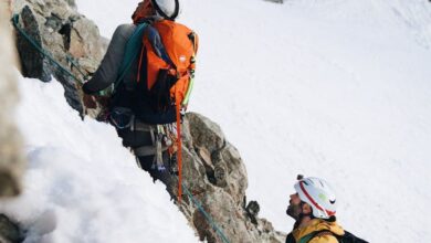 Ice Climbing Gear - Two climbers ascend a snowy mountain, showcasing outdoor adventure and teamwork.