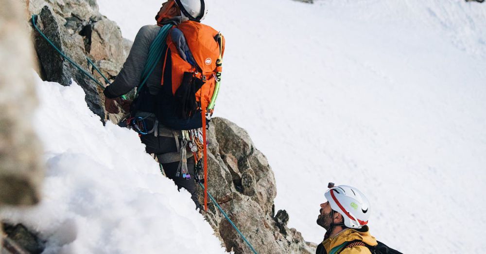 Ice Climbing Gear - Two climbers ascend a snowy mountain, showcasing outdoor adventure and teamwork.