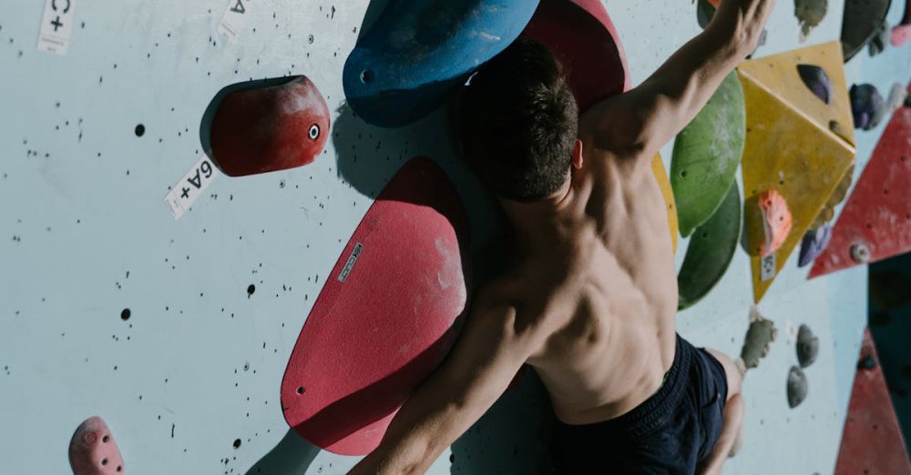 Climbing Skills - Shirtless male rock climber scales colorful indoor climbing wall with focus and agility.