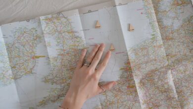 Adventure Routes - A hand on a map suggests travel and exploration, ideal for wanderlust vibes.