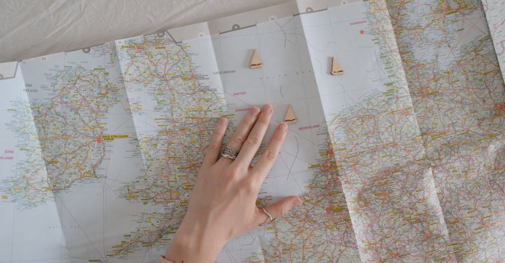 Adventure Routes - A hand on a map suggests travel and exploration, ideal for wanderlust vibes.