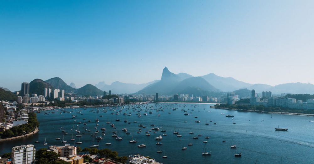 Popular Locations - Captivating aerial view of Rio de Janeiro's skyline and coastline under clear blue skies.