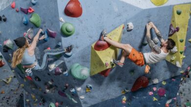 Challenging Routes - Two active climbers tackle a challenging indoor rock climbing wall, showcasing skill and athleticism.