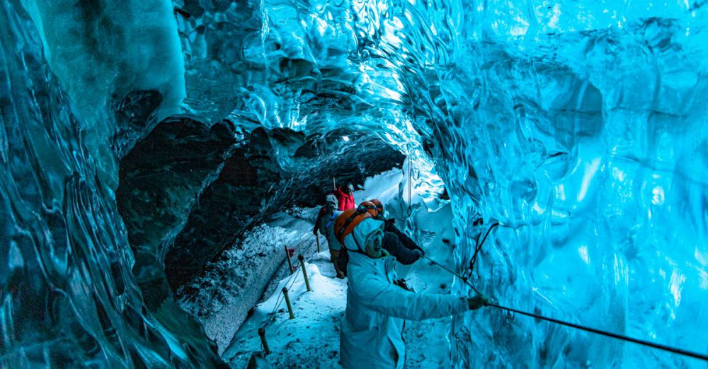 Choosing Glacier Tour - Group exploring a stunning blue ice cave, showcasing glacial textures and colors.