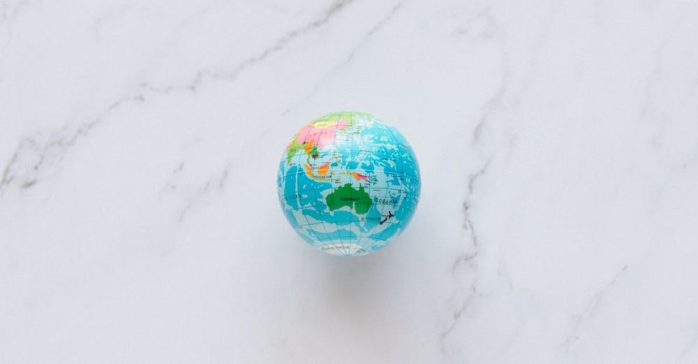 Tour Preparation - A small, colorful globe rests on a marble surface, symbolizing global exploration and travel planning.