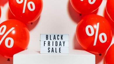 Deals - Red balloons with percentage symbols flank a Black Friday Sale sign, creating a festive shopping atmosphere.