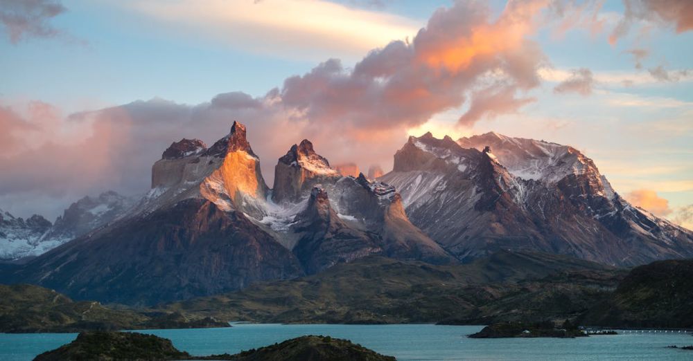 Scenic Glacier Views - Breathtaking view of Torres del Paine at sunset with snowcapped peaks and vibrant sky.