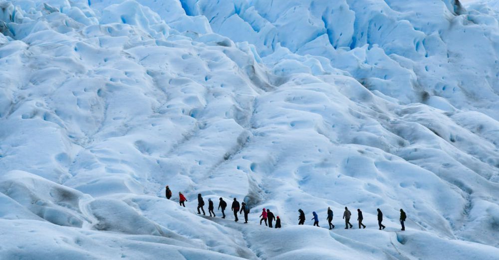 Budget Glacier Tours - A group of hikers trekking across a vast icefield in Patagonia, Argentina, showcasing the stunning icy landscape.