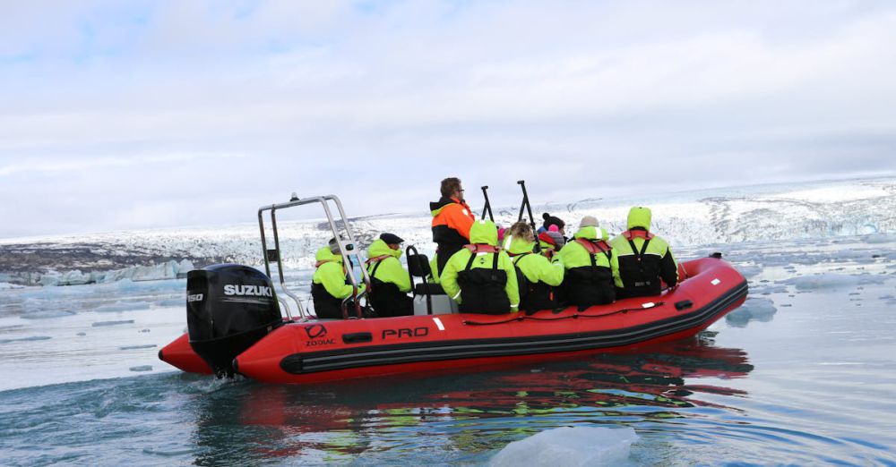 Photography Glacier Tours - Group enjoying thrilling Zodiac boat ride amidst Iceland's icy landscape.