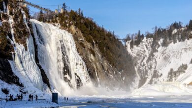 Quebec Glacier Tours - Frozen waterfall cascading down a snowy mountain under a blue sky, perfect for winter nature photography.