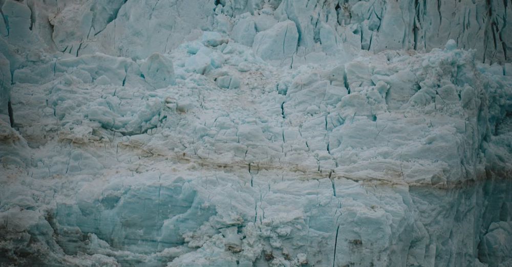 Educational Glacier Tours - A breathtaking view of a towering glacier ice wall in an arctic landscape highlighting climate change.