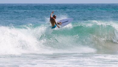 Surfing Photography - A person riding a surfboard on top of a wave