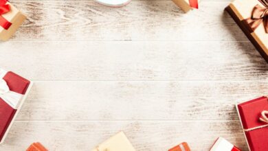 Gifts - A top view of colorful gift boxes arranged on a rustic wooden table, perfect for holiday themes.