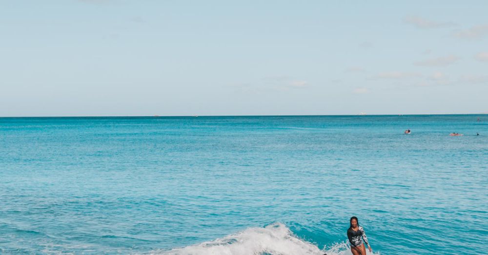 Group Surfing - A group of surfers catching waves in the pristine waters of Oahu, Hawaii, showcasing perfect island harmony.