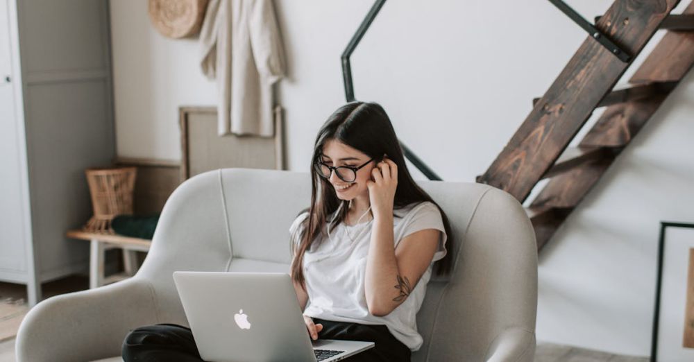 Weekend Surfing - A woman sits comfortably on a sofa using a laptop in a modern living room.