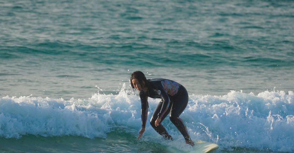 Surfing Fitness - Surfer catching a wave on a sunny day at the beach. Energetic and adventurous.