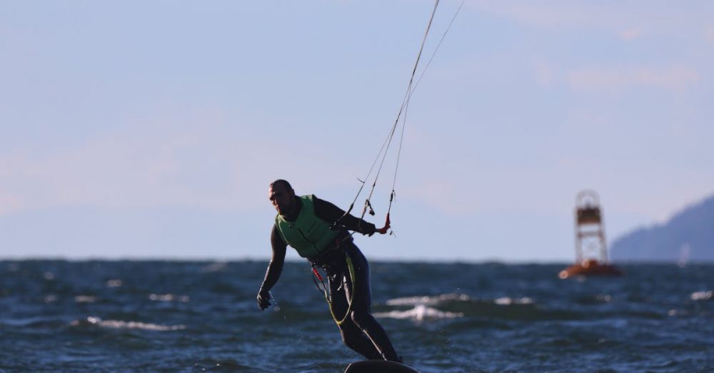 Vancouver Surfing - A kitesurfer rides the waves in Vancouver, capturing the essence of adventure sports.