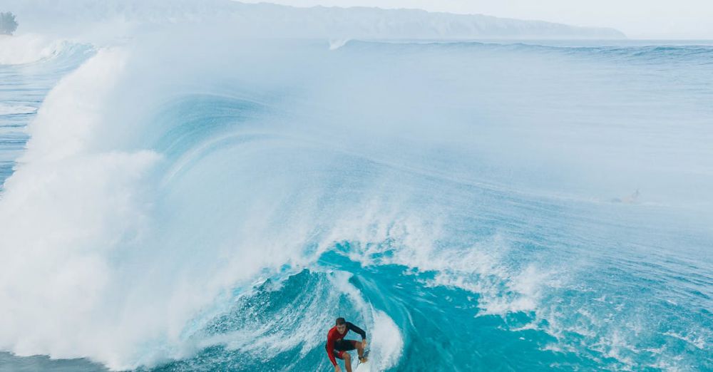 Surfing Technique - Dynamic shot of a surfer riding a big wave at the iconic Pipeline in Haleiwa, Hawaii.