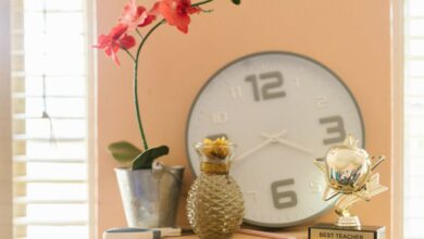 Best Time - Home office shelf with orchids, clock, and best teacher trophy.