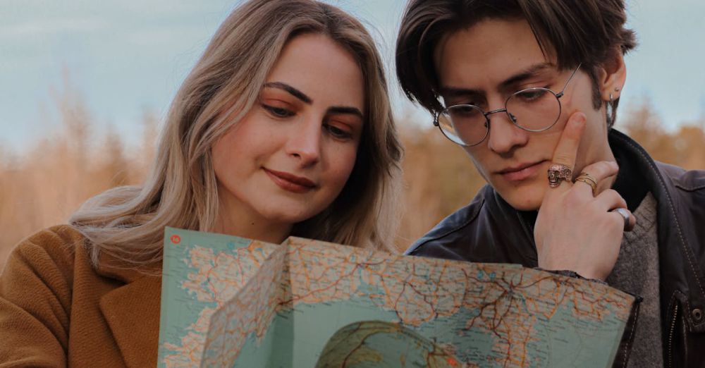 Fall Tour Planning - Couple examining a map outdoors, planning their travel route under a blue sky.