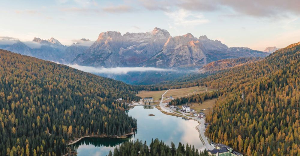 Photography Tours - Breathtaking aerial view of a tranquil lake surrounded by mountains in autumn, perfect for travel and nature enthusiasts.