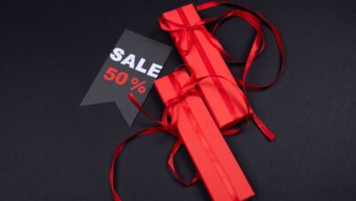 Affordable Gifts - Red gift boxes with ribbons and a 50% sale tag on a dark background.