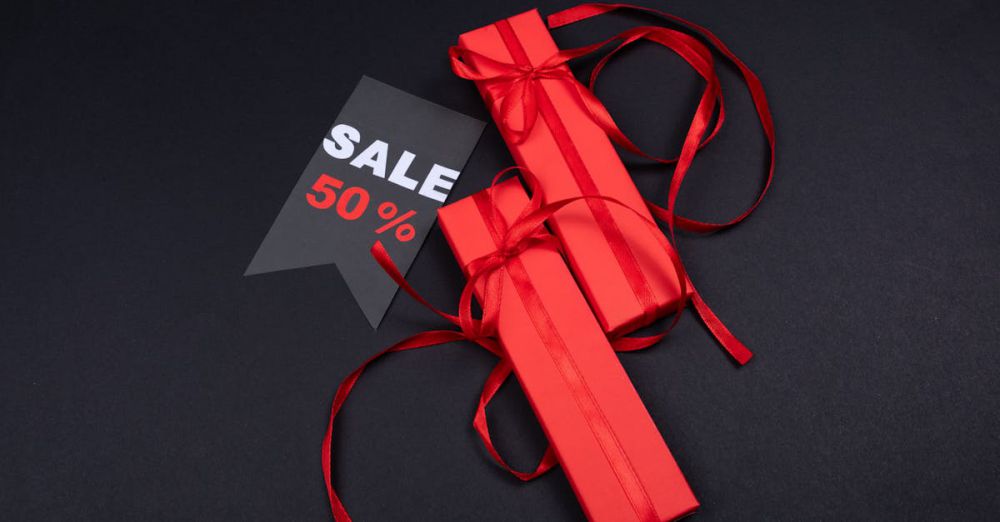 Affordable Gifts - Red gift boxes with ribbons and a 50% sale tag on a dark background.