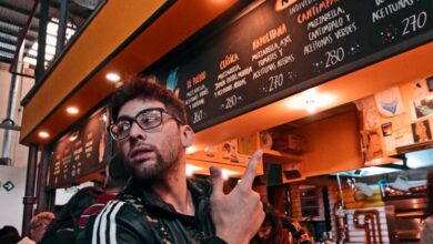 Popular Destinations - Man enjoying a lively evening at Penacho Bar in Buenos Aires, Argentina.