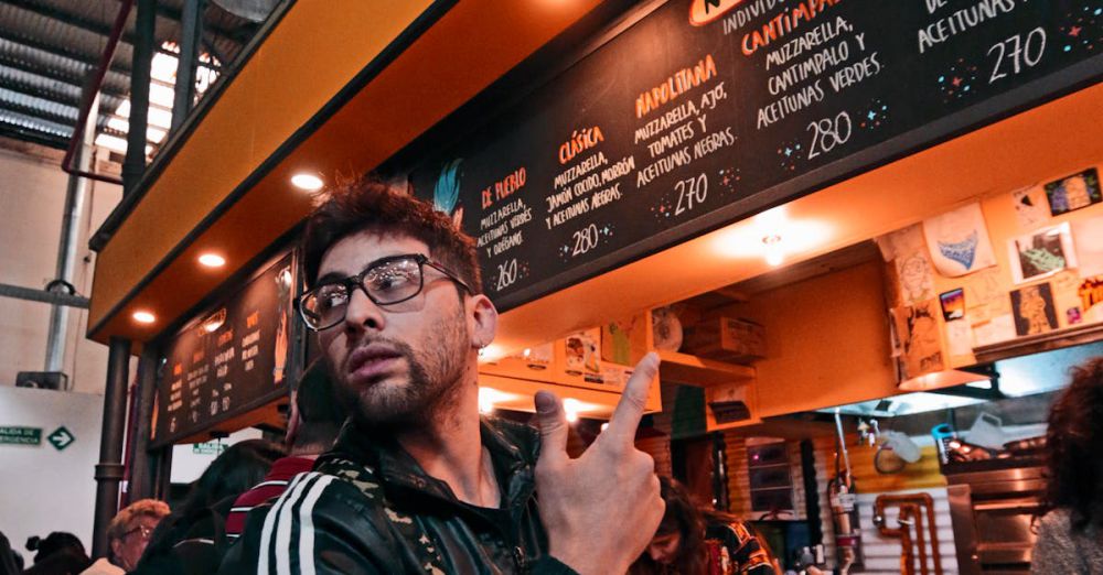 Popular Destinations - Man enjoying a lively evening at Penacho Bar in Buenos Aires, Argentina.