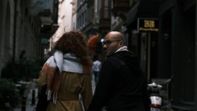 Couple Tours - Couple strolling along Istanbul's cobblestone streets with a view of Galata Tower in the distance.