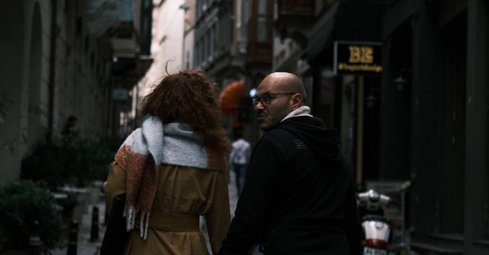 Couple Tours - Couple strolling along Istanbul's cobblestone streets with a view of Galata Tower in the distance.