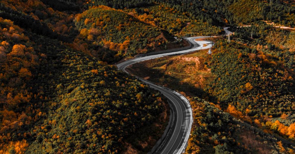 Scenic Drives - Stunning aerial view of winding road through colorful autumn hills in Çınarcık, Türkiye.