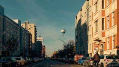 Outdoor Activities - A scenic view of a busy street in Berlin, featuring a hot air balloon and bikes.