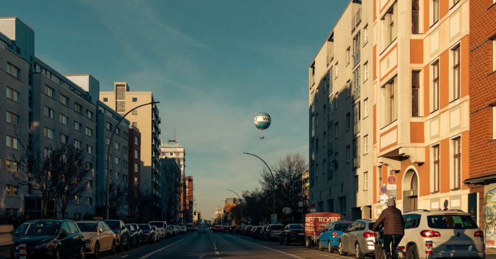 Outdoor Activities - A scenic view of a busy street in Berlin, featuring a hot air balloon and bikes.