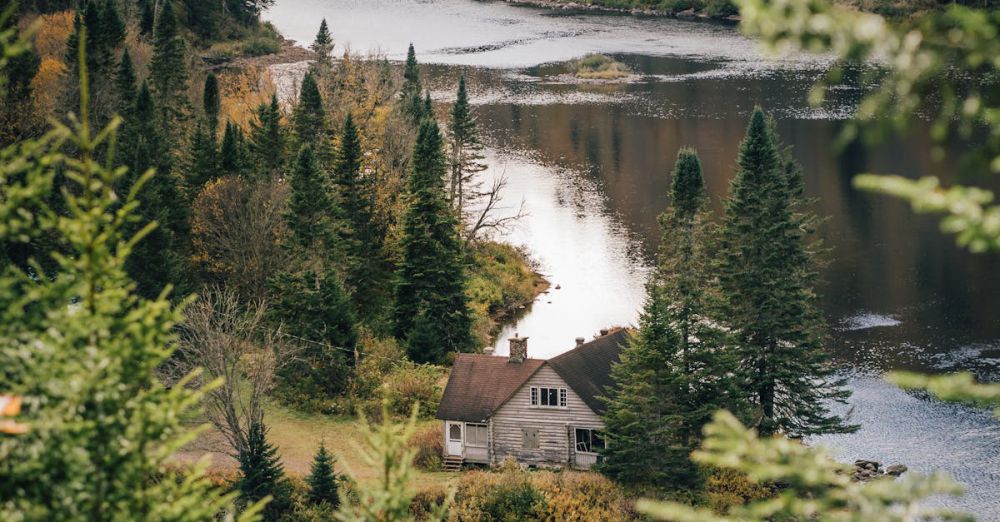 Quebec Foliage - A serene autumn landscape featuring a secluded lakeside chalet surrounded by vibrant fall foliage in Québec, Canada.