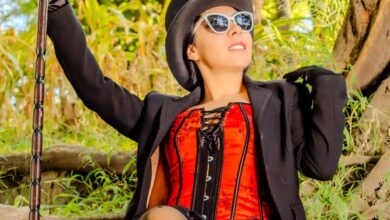 Custom Foliage Tour - Woman in steampunk attire and sunglasses sitting in a natural outdoor setting.