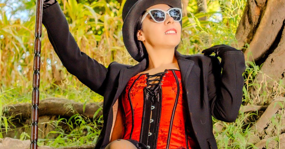 Custom Foliage Tour - Woman in steampunk attire and sunglasses sitting in a natural outdoor setting.