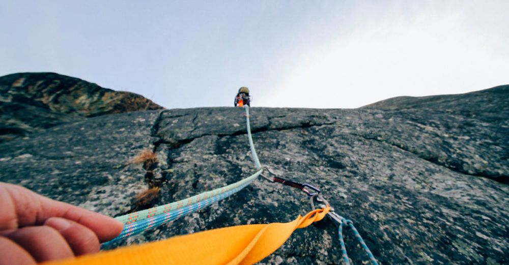 Climbing Gear - Capture the thrill of rock climbing with this dynamic low-angle shot showcasing determination and teamwork.