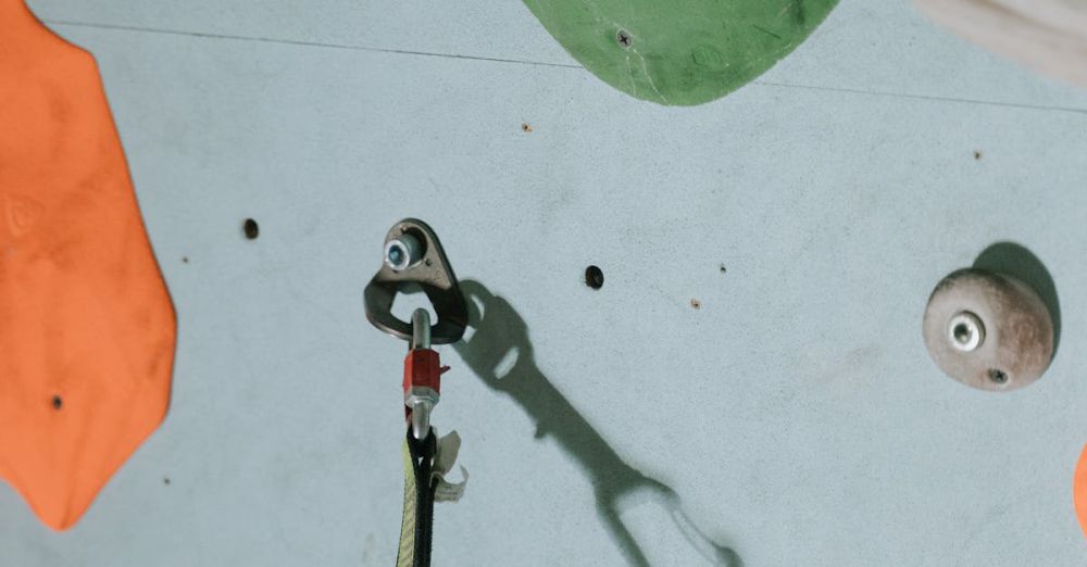 Climbing Safety - Close-up of a climbing wall with colorful holds and a carabiner, perfect for indoor climbing activities.