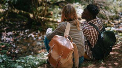 Couple Routes - Two friends sitting in a tranquil forest setting, enjoying nature and each other's company.