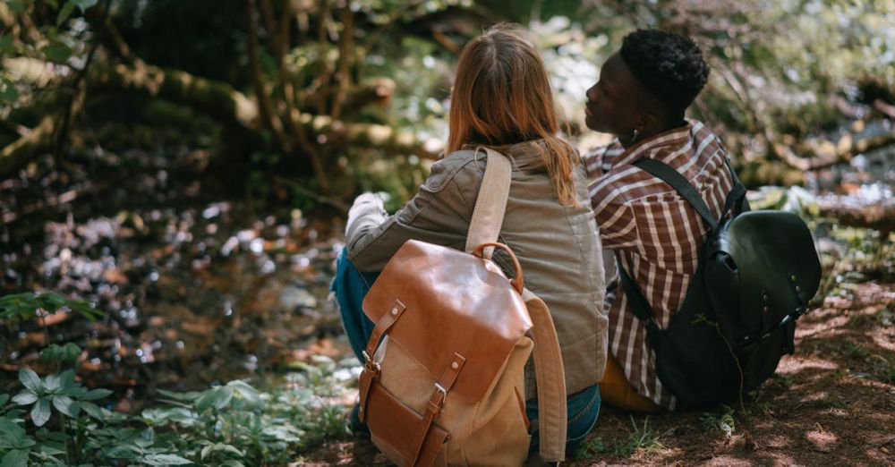 Couple Routes - Two friends sitting in a tranquil forest setting, enjoying nature and each other's company.