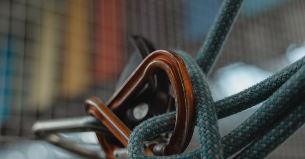 Technical Climbs - Detailed close-up of climbing gear featuring a rope and carabiners, highlighting the intricate knots.