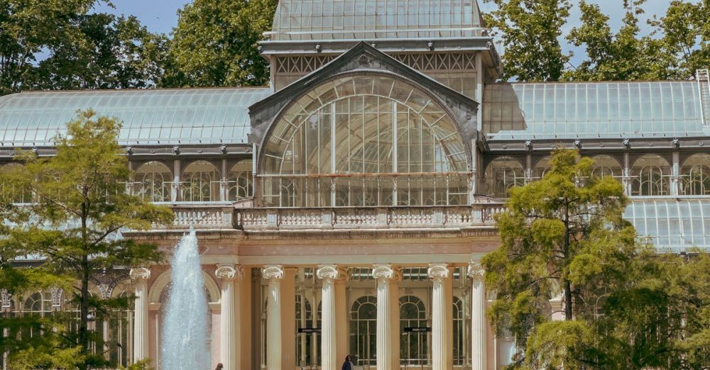 Beautiful Gardens - The stunning Crystal Palace in Madrid's Buen Retiro Park on a sunny day.