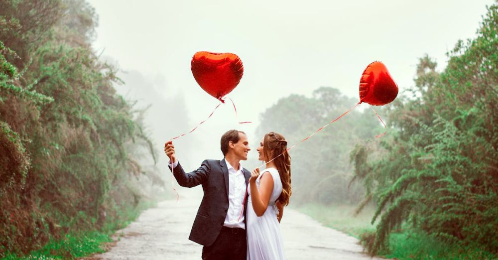 Couple Gardens - A loving couple embraces with heart-shaped balloons in a foggy park setting.