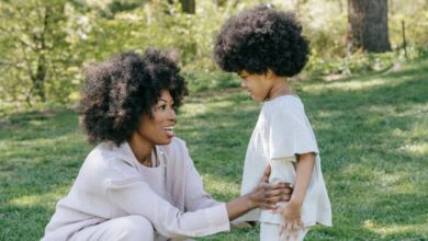 Kids In Gardens - Happy mother and daughter bonding outdoors in matching outfits, showcasing love and style in a serene park.