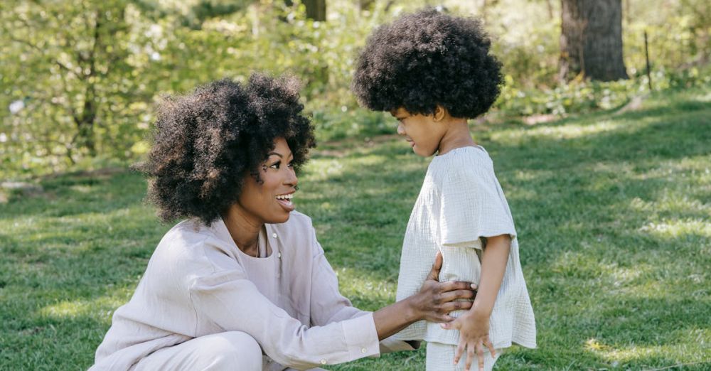 Kids In Gardens - Happy mother and daughter bonding outdoors in matching outfits, showcasing love and style in a serene park.