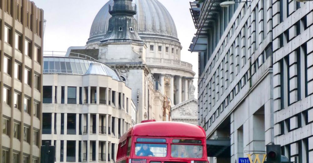 City Museums - A classic red double-decker bus in front of St Paul's Cathedral, capturing London's charm.