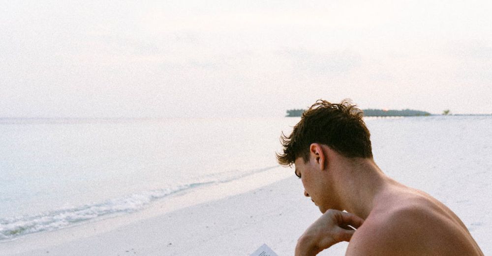 Books - A man enjoys reading a book on a serene Maldives beach, capturing the essence of relaxation.