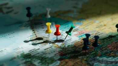 Route Selection - A close-up view of colorful push pins marking locations on a detailed world map.